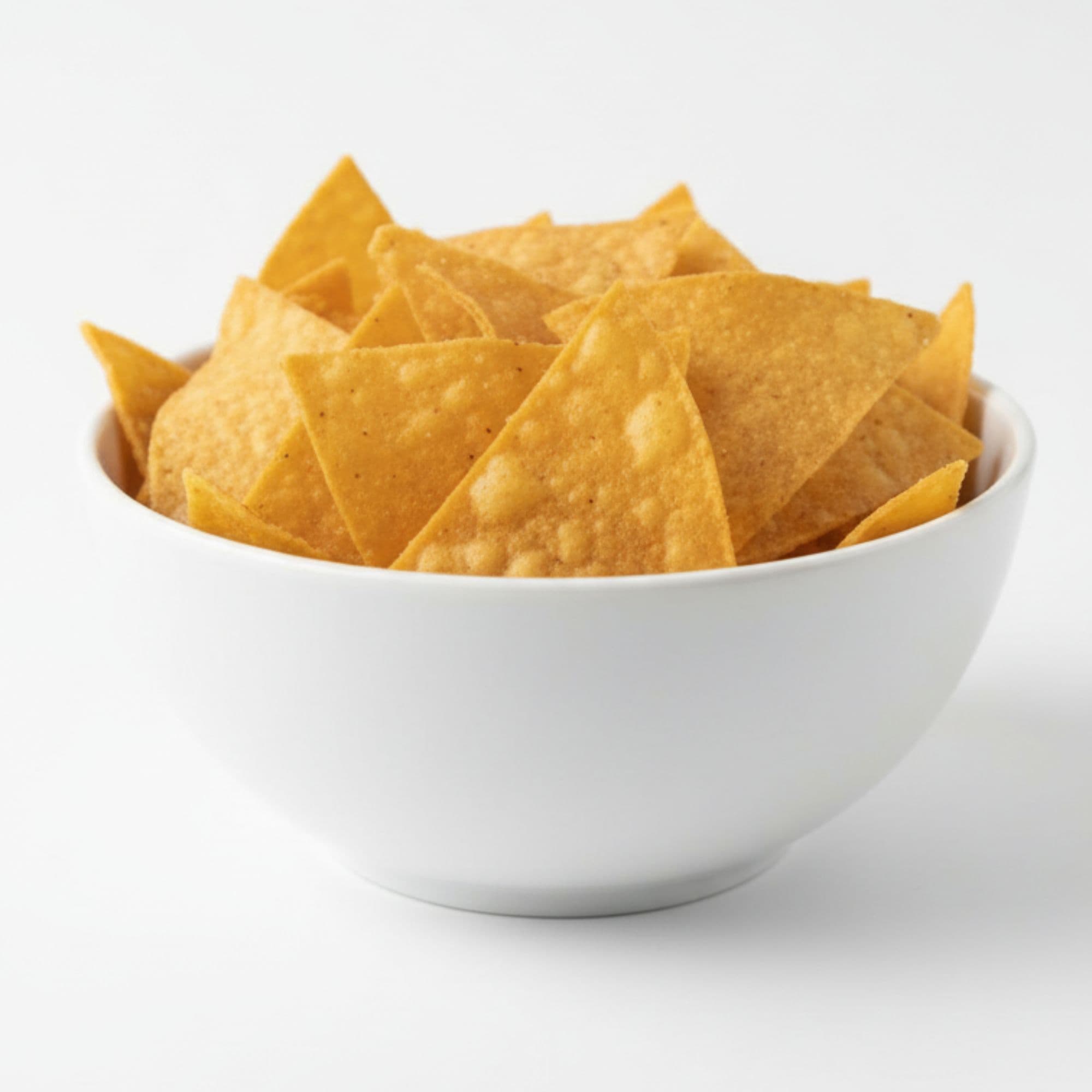 Restaurant food photo after AI enhancement - Re-staged from informal paper bag takeout presentation to a professional white ceramic bowl. Bright, even lighting highlights the golden color and crisp texture of the chips, creating an appetizing restaurant-quality image.